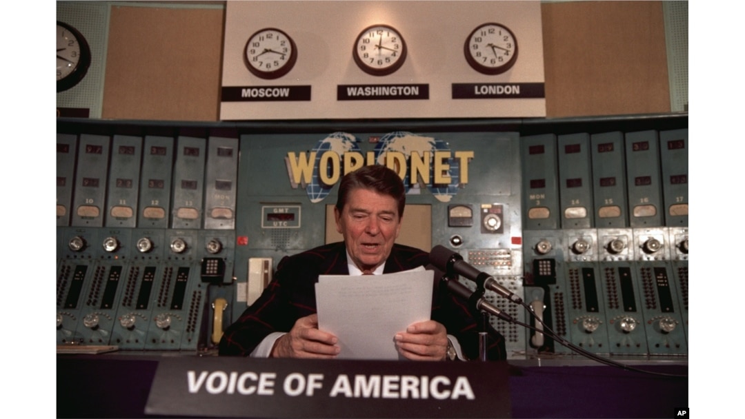FILE - President Ronald Reagan gives his weekly radio address at the Voice of America studio in Washington, Nov. 9, 1985.