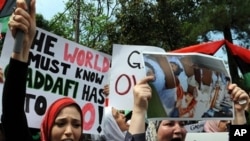 Libyan protesters shout slogans against Libyan leader Gadhafi in front of the Libyan embassy in Kuala Lumpur on February 23, 2011.