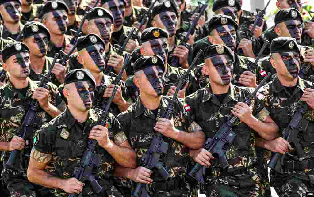 Lebanese Army commandos march in a military parade during an official ceremony commemorating the country&#39;s 73rd independence day in the capital Beirut.
