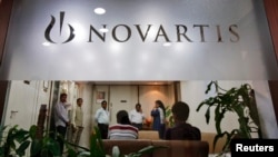 People gather at Novartis India headquarters in Mumbai April 1, 2013.