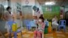 FILE - A girl receives a dose of the Sinovac Covid-19 coronavirus vaccine at a health centre in Phnom Penh on November 1, 2021, as Cambodia begins vaccinating children from aged five and older. (Photo by TANG CHHIN Sothy / AFP)