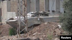 A Syrian government military vehicle is seen in Talbiseh near Homs, Syria, May 22, 2012.