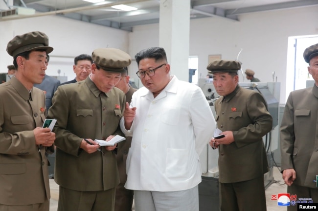 North Korean leader Kim Jong Un gives field guidance during his visit to a machine factory under the Ranam Coal Mining Machine Complex in this undated photo released by North Korea's Korean Central News Agency in Pyongyang, July 17, 2018.