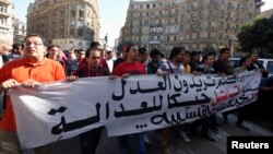 Protesters shout anti-government slogans during a rally against a new law restricting public gatherings, in downtown Cairo Nov. 26, 2013.