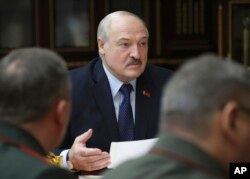 Belarusian President Alexander Lukashenko attends a meeting with military top officials in Minsk, Belarus, Jan.17, 2022.