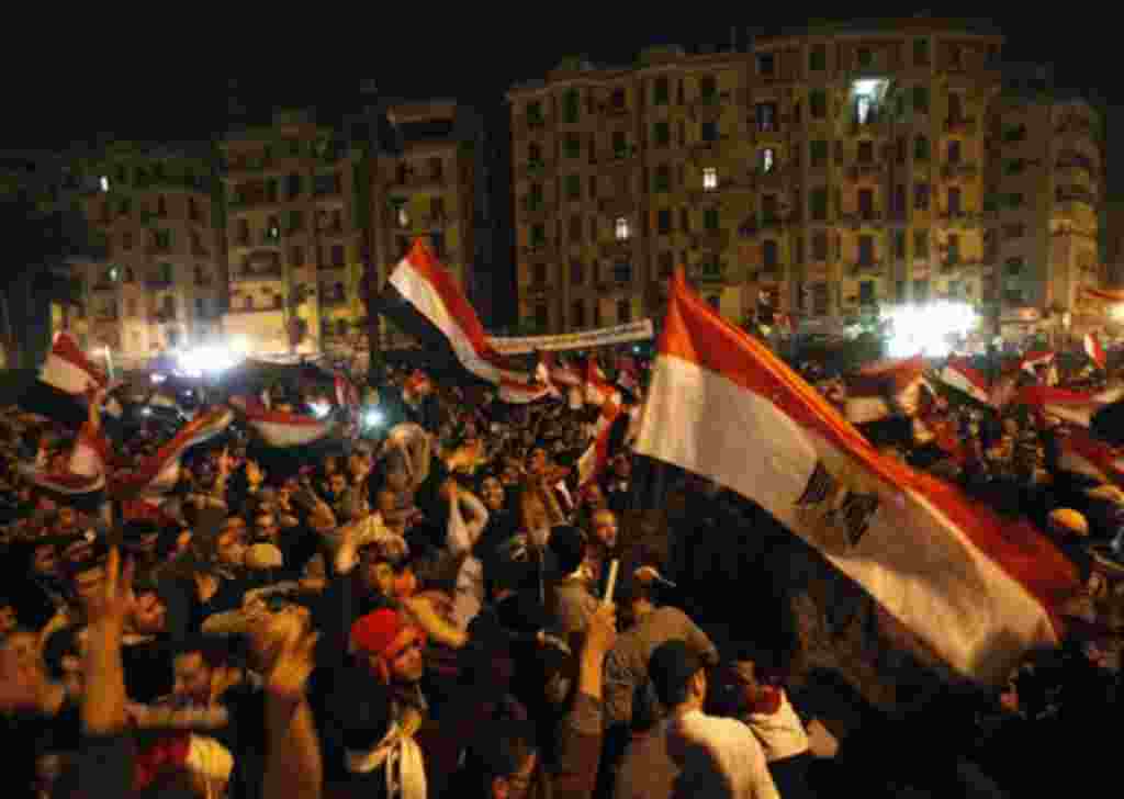 Egyptian citizens wave their national flags as they celebrate after President Hosni Mubarak resigned and handed power to the military at Tahrir Square, in Cairo, Egypt, Friday, Feb. 11, 2011. Egypt exploded with joy, tears, and relief after pro-democracy 