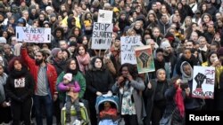 FILE - Protesters attend a demonstration against slavery in Libya, in Stockholm, Sweden, Nov. 25, 2017. 
