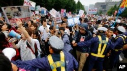 Protesters stage a rally in front of the National Diet building in Tokyo, Aug. 30, 2015. 