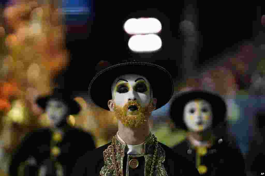 A performer from the Sao Clemente samba school parades during carnival celebrations at the Sambadrome in Rio de Janeiro, Brazil, Feb. 24, 2020.