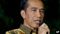 FILE - Indonesian President-elect Joko Widodo speaks during a press conference at his residence in Jakarta, Indonesia.