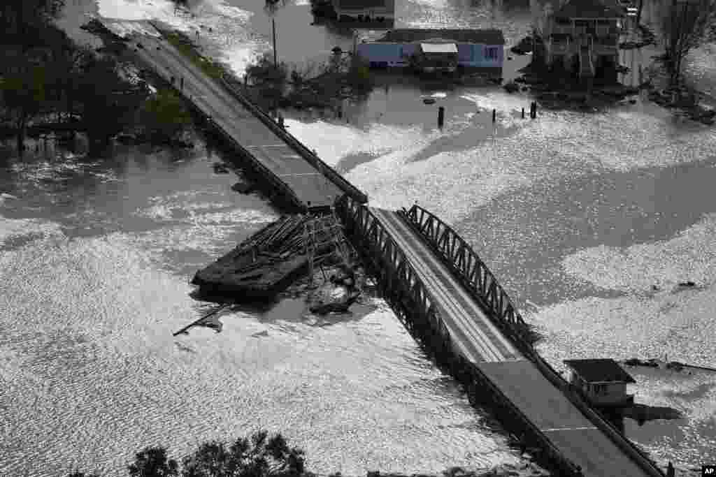 A barge damages a bridge that divides Lafitte, Louisisna, and Jean Lafitte, in the aftermath of Hurricane Ida, Aug. 30, 2021, in Lafitte.