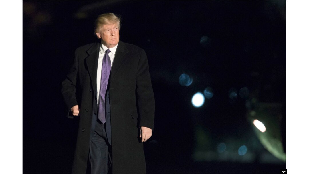 FILE - President Donald Trump walks on the South Lawn upon arrival at the White House in Washington from a trip to Florida, Feb. 12, 2017.
