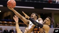 University of Michigan guard Derrick Walton Jr. (10) is fouled as he shoots by Oklahoma State University forward Leyton Hammonds (23) during a first-round game in the men's NCAA college basketball tournament in Indianapolis, Indiana, March 17, 2017.