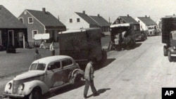 People move into new homes in Levittown, New York, in October 1947. Levittown served as a model for planned communities for the baby boom generation.