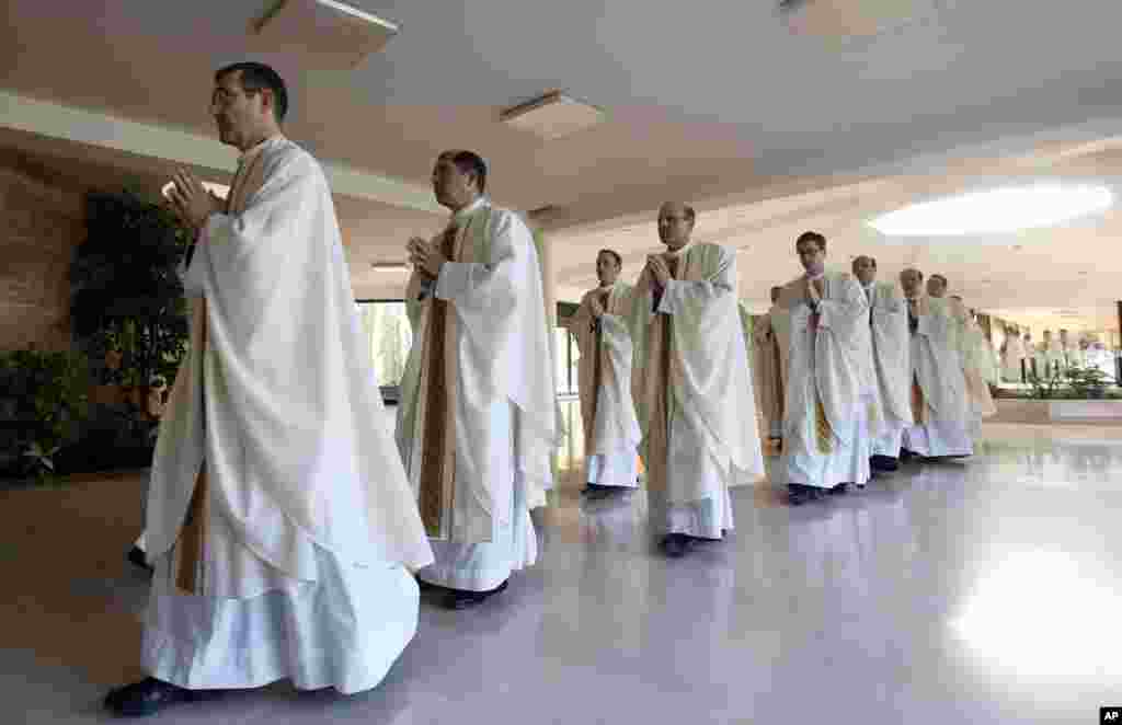 FILE - Prelates arrive for a mass celebrated by Cardinal Velasio De Paolis in the Legion of Christ main headquarters, the Ateneo Pontificio Regina Apostolorum, in Rome, Feb. 25, 2014. 