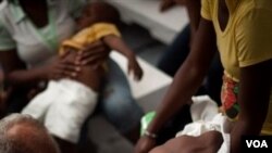 Seorang dokter di rumah sakit Haiti memeriksa anak yang mengalami gejala kolera.