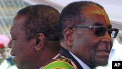 Zimbabwean President Robert Mugabe (R) and Prime Minister Morgan Tsvangirai arrive at a rally marking Zimbabwe's 31st independence anniversary celebrations in Harare, Zimbabwe, April 2011. (file photo)