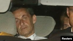 Mantan Presiden Perancis Nicolas Sarkozy tiba dalam mobil polisi di unit investigasi finansial di Paris (1/7). 