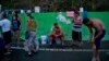 People affected by Hurricane Maria wait in line to collect water piped from a creek in the mountains, in Naranjito, Puerto Rico, Sept. 28, 2017. Residents of the area drive to the pipes to bathe because they were left without water by the damage caused by Hurricane Maria. The pipe was set up by a neighbor who ran it from a creek in his property to the side of the road in order to help those left without water. 