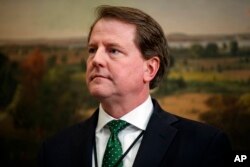 White House counsel Don McGahn waits for the arrival of President Donald Trump to a bill signing for the "Economic Growth, Regulatory Relief, and Consumer Protection Act," in the Roosevelt Room of the White House, May 24, 2018, in Washington.