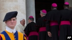 FILE- Pope Francis greets bishops at the end of his weekly general audience, at the Vatican, April 30, 2014. 