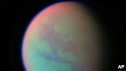 This false-color composite was created with images taken during the Cassini spacecraft's closest flyby of Titan, April 2005. (file photo)