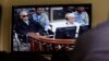 FILE - Khieu Samphan (2-L), former Khmer Rouge head of state, and Noun Chea (L), who was the Khmer Rouge's chief ideologist and No. 2 leader, are seen on a screen at the court's press center of the U.N.-backed war crimes tribunal in Phnom Penh, Cambodia, Aug. 7, 2014.