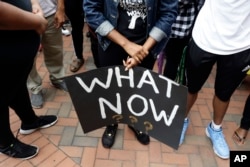 Students at the University of North Carolina-Charlotte hold a vigil following Tuesday's police shooting of Keith Lamont Scott at The Village at College Downs apartment complex in Charlotte, N.C., Sept. 21, 2016.