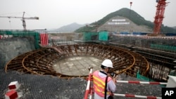 FILE: A journalist looks at the Sanmen Nuclear Power Plant in Sanmen, east China's Zhejiang Province. Taken Thursday June 4, 2009