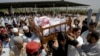 Relatives and friends carry the coffin bearing a former Pakistani intelligence officer Khalid Khawaja, who was killed by unknown militants, during his funeral in Islamabad, Pakistan, May 2, 2010. 