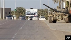 In this photo taken during a trip organized by Libyan authorities, a Libyan tank stands at in the outskirts of the coastal city of Misrata, 125 miles (200 kilometers) southeast of Tripoli, April 8, 2011