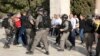 Palestinians and Israeli border police officers scuffle inside the Al-Aqsa Mosque compound, July 27, 2017. 