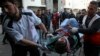 Medics move a wounded youth, who was shot by Israeli troops during a protest at the Gaza Strip's border with Israel, into the treatment room of Shifa hospital in Gaza City, Friday, March 22, 2019.