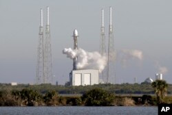 A Falcon 9 SpaceX rocket, stands ready at space launch complex 40, shortly before the launch was scrubbed because of a technical issue at the Cape Canaveral Air Force Station in Cape Canaveral, Fla., Dec. 18, 2018.