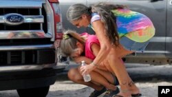 Nancy Register weeps as she is comforted by Roxie Cline, right, after she lost her home and all its contents to Hurricane Michael in Mexico Beach, Fla., Oct. 17, 2018. Register said she doesn't know how she and her husband will make it through this, saying they only have money to last them four more days.