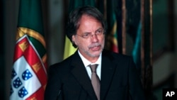 FILE - Mozambique's writer Mia Couto gives a speech after he receives the Camoes Prize at the National Palace of Queluz, in Queluz, near Lisbon, June 10, 2013. 