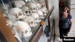 Tourists visit a memorial to victims of the Khmer Rouge regime near Phnom Penh.