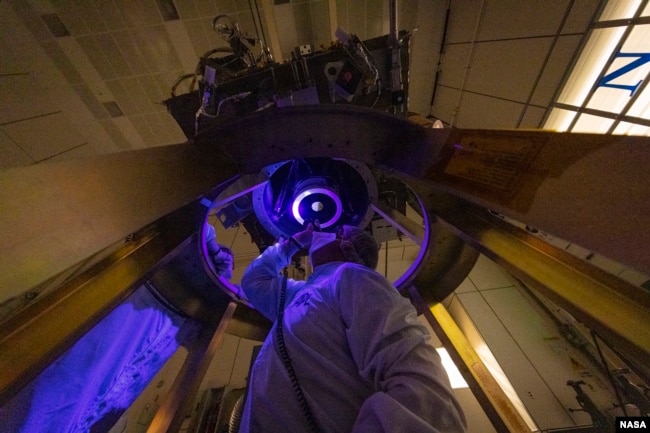 DART team members install and inspect the spacecraft’s DART's only instrument - the Didymos Reconnaissance and Asteroid Camera for Optical navigation (DRACO) - onto the spacecraft in June 2021. (Image Credit: NASA/Johns Hopkins APL/Ed Whitman)