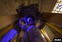 DART team members install and inspect the spacecraft’s DART's only instrument - the Didymos Reconnaissance and Asteroid Camera for Optical navigation (DRACO) - onto the spacecraft in June 2021. (Image Credit: NASA/Johns Hopkins APL/Ed Whitman)