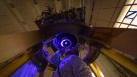 DART team members install and inspect the spacecraft’s DART's only instrument - the Didymos Reconnaissance and Asteroid Camera for Optical navigation (DRACO) - onto the spacecraft in June 2021. (Image Credit: NASA/Johns Hopkins APL/Ed Whitman)