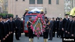 Firefighters attend the funeral service of General Mohamed Saeed, head of the technical office of the minister of interior, in Cairo, Egypt, Jan. 28, 2014.