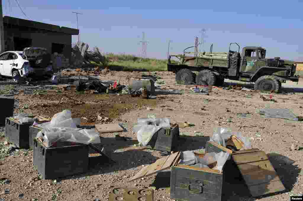 Ammunition and an abandoned military truck belonging to forces loyal to President Bashar Al-Assad is seen after clashes in Raqqa province, eastern Syria, June 16, 2013.