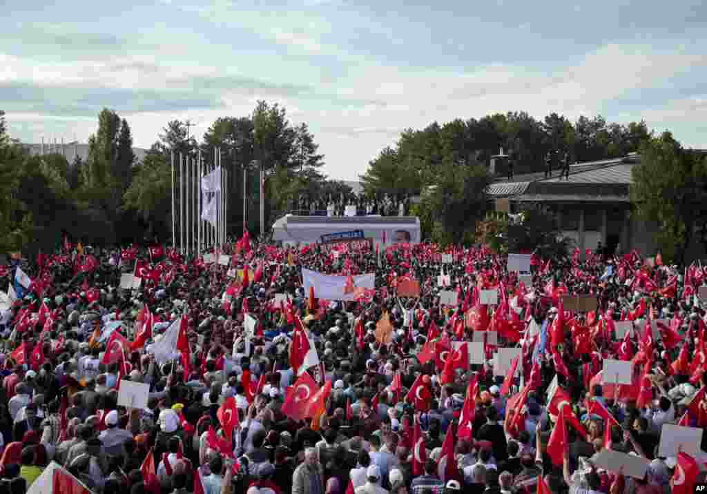 Supporters of Turkish Prime Minister Recep Tayyip Erdogan listen to his speech at the Ankara airport, June 9, 2013. 