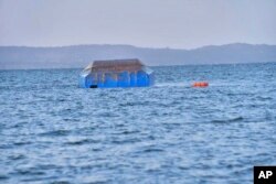 The upside-down-turned passenger ferry MV Nyerere floats in the water near Ukara Island in Lake Victoria, Tanzania, Sept. 21, 2018, after it capsized.