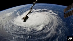 This photo provided by NASA shows Hurricane Florence from the International Space Station on Monday, Sept. 10, 2018, as it threatens the U.S. East Coast. (NASA via AP)