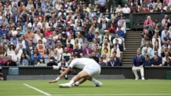 Serbia's Novak Djokovic slips on the grass during the men's singles second round match against South Africa's Kevin Anderson on day three of the Wimbledon Tennis Championships in London, Wednesday June 30, 2021. (AP Photo/Alastair Grant)