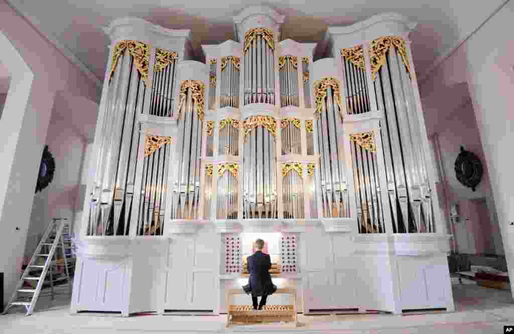 Emmanuel Le Divellec, professor of Church Music at the Hochschule f&#39;r Musik, Theater und Medien Hannover (HMTMH), plays the new baroque organ in the Neustadt Stadt- und Hofkirche St. Johannis in Hannover, Germany.