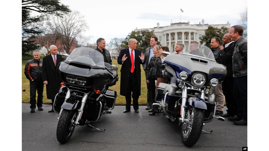 FILE - President Donald Trump and Vice President Mike Pence meet with Harley Davidson executives and Union Representatives on the South Lawn of the White House in Washington, Feb. 2, 2017.