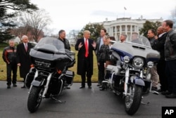 FILE - President Donald Trump and Vice President Mike Pence meet with Harley Davidson executives and Union Representatives on the South Lawn of the White House in Washington, Feb. 2, 2017.