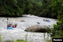 A group of the press and government representatives practice rafting guided by ex-FARC rebels in Miravalle, Colombia, Nov. 9, 2018.